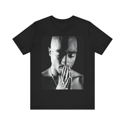 A black graphic t-shirt featuring a black and white streetwear rebel graphic of Tupac.