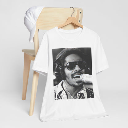 A black graphic t-shirt featuring a graphic of Stevie Wonder as a timeless visionary.