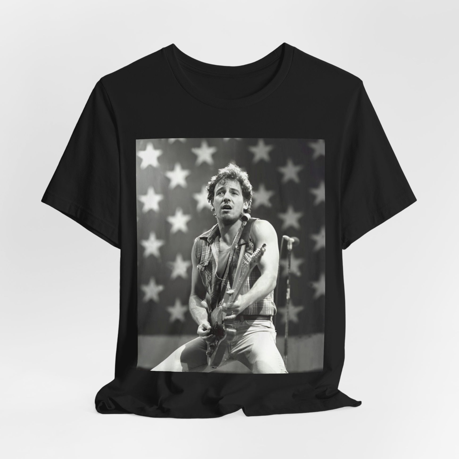 A black graphic t-shirt featuring a black and white graphic of Bruce Springsteen with an American flag background or elements.