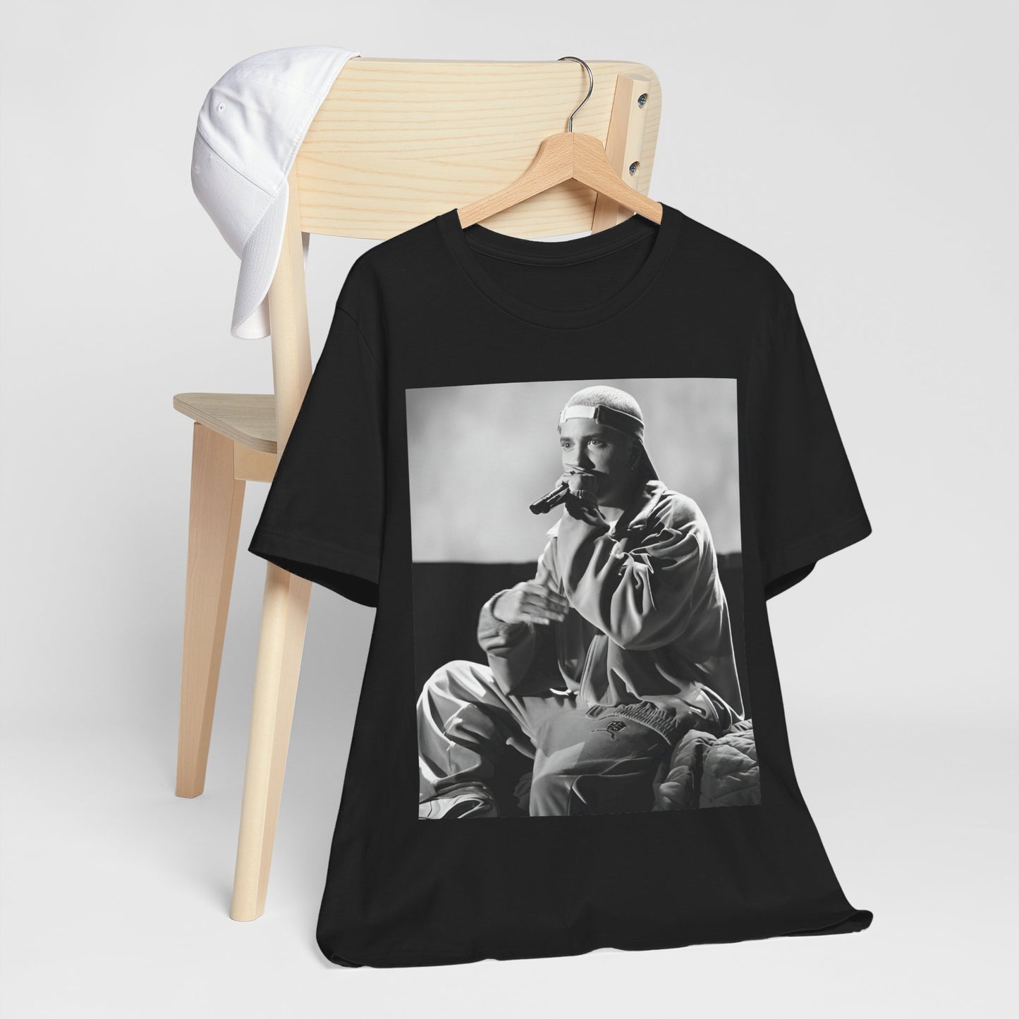 A black graphic t-shirt featuring a black and white graphic of Eminem as a 'Rap Messiah'.