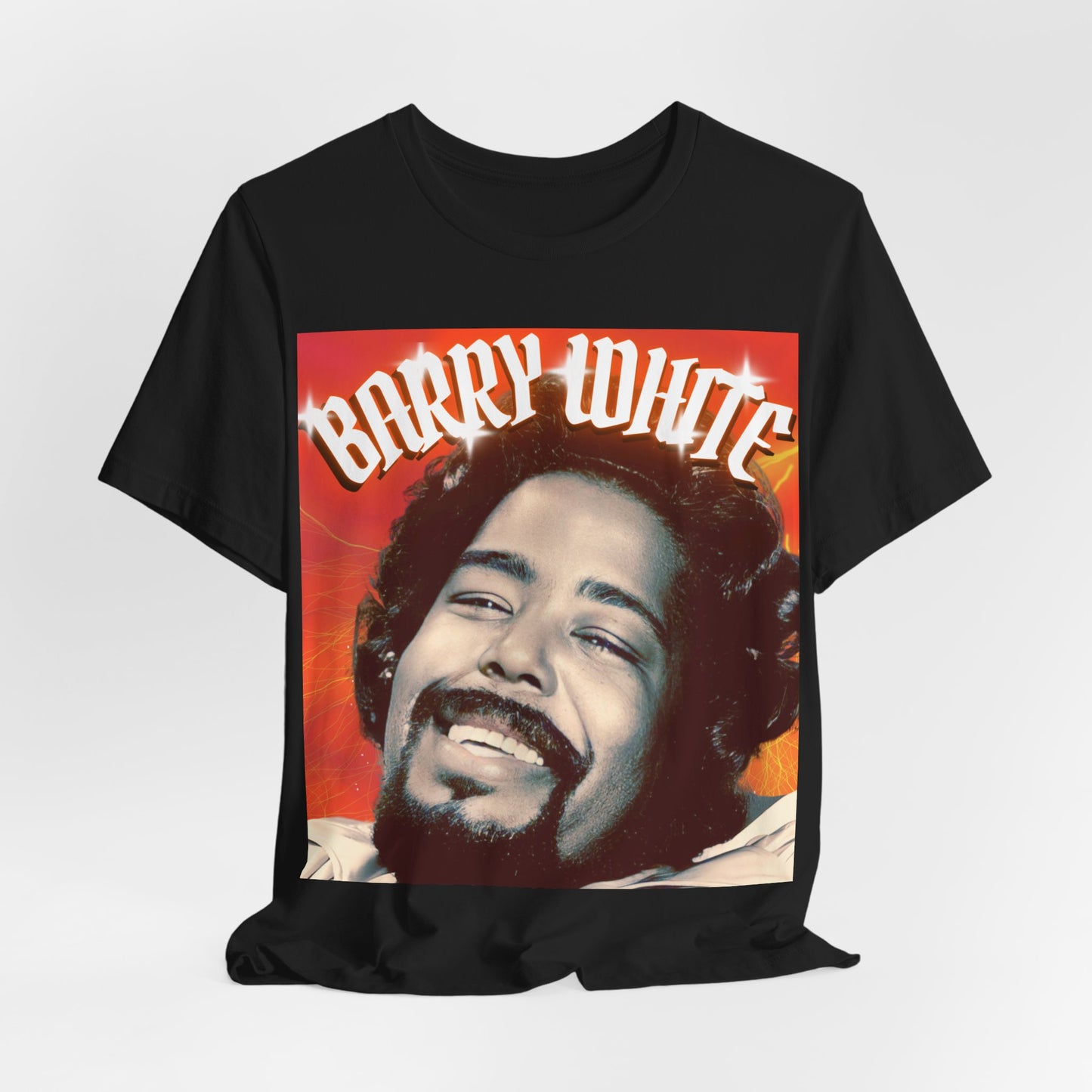 A black graphic t-shirt featuring a graphic of Barry White, emphasizing his iconic soulful presence from the 1970s.