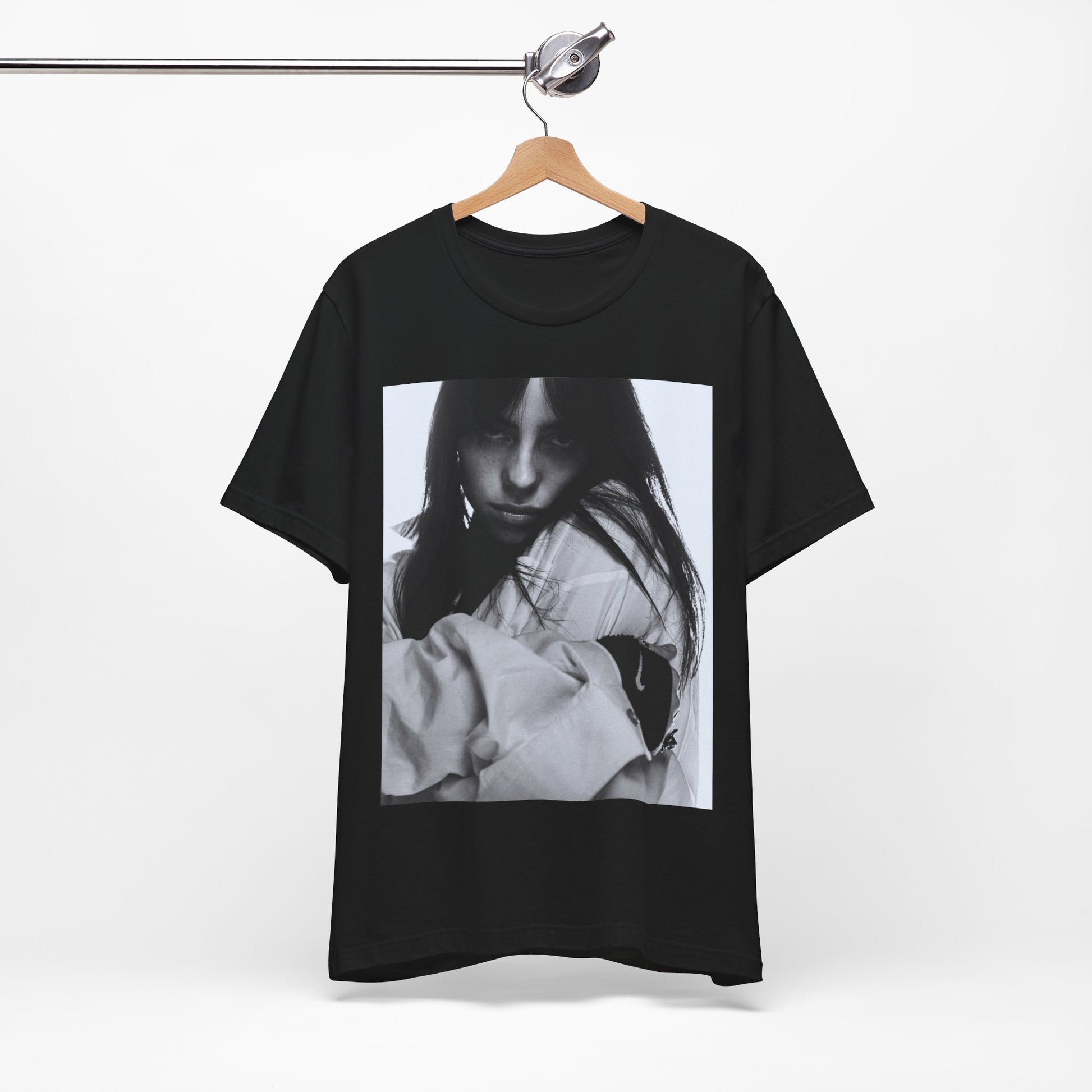 Billie Eilish posing in her signature oversized designer streetwear, printed on a graphic t-shirt.
