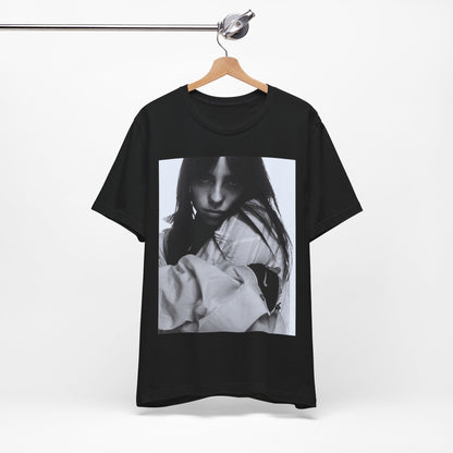 Billie Eilish posing in her signature oversized designer streetwear, printed on a graphic t-shirt.