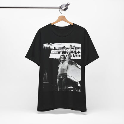 A black graphic t-shirt featuring an epic arena rock graphic of Bon Jovi performing on a large stage.