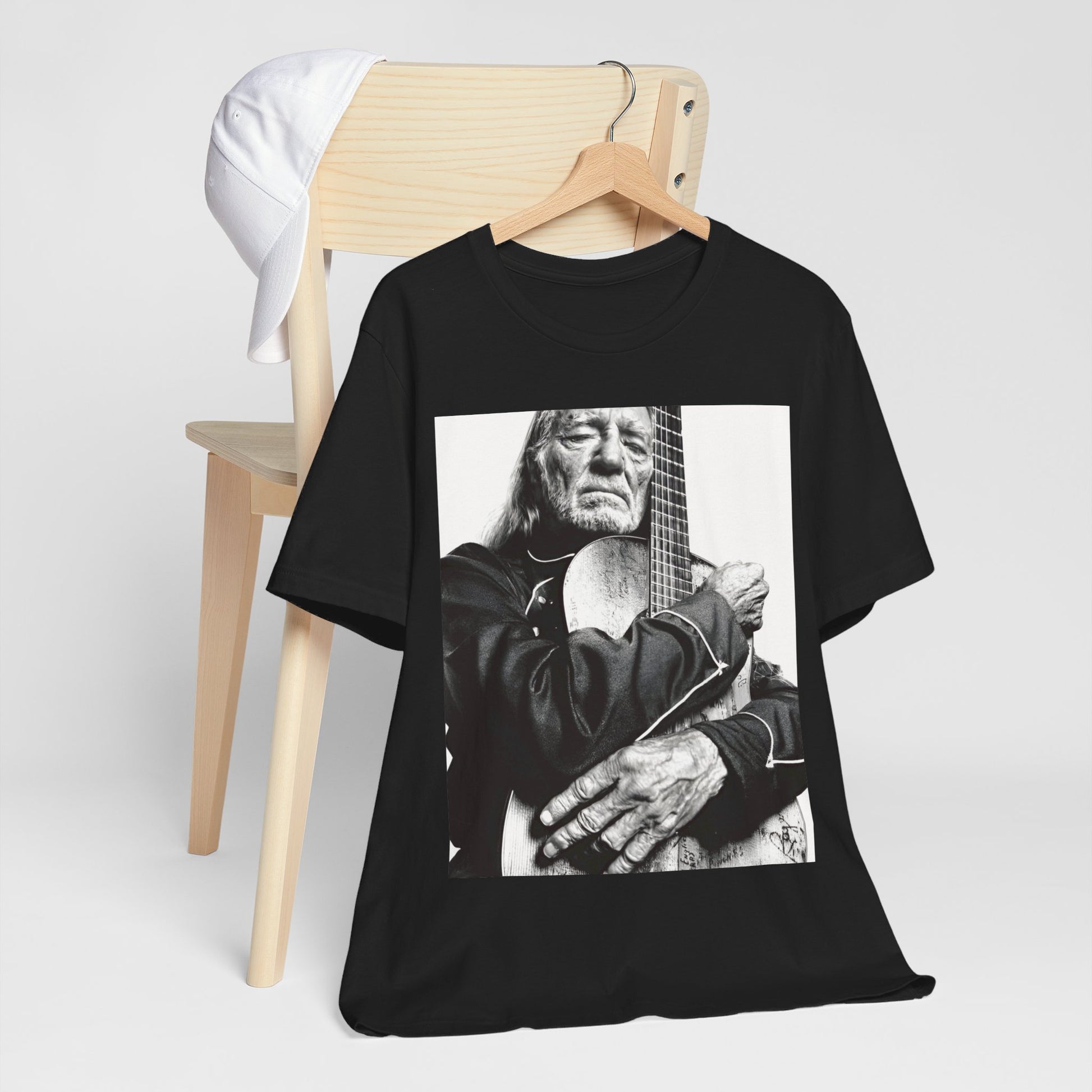 A black graphic t-shirt featuring a vintage country legend graphic of Willie Nelson.