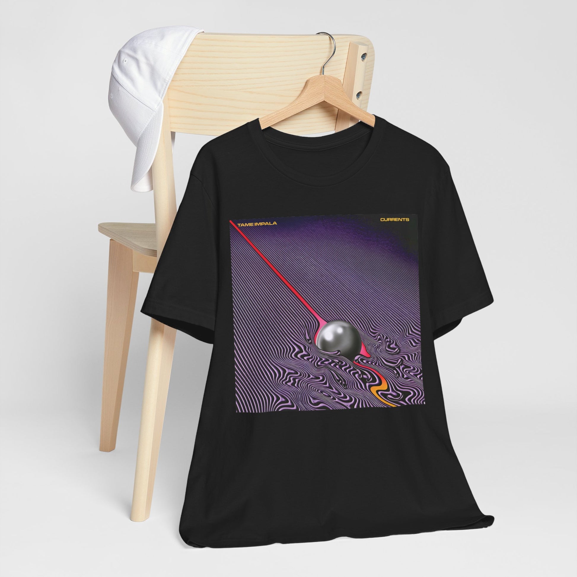 A black graphic t-shirt featuring a graphic related to Tame Impala's 'Currents' album.
