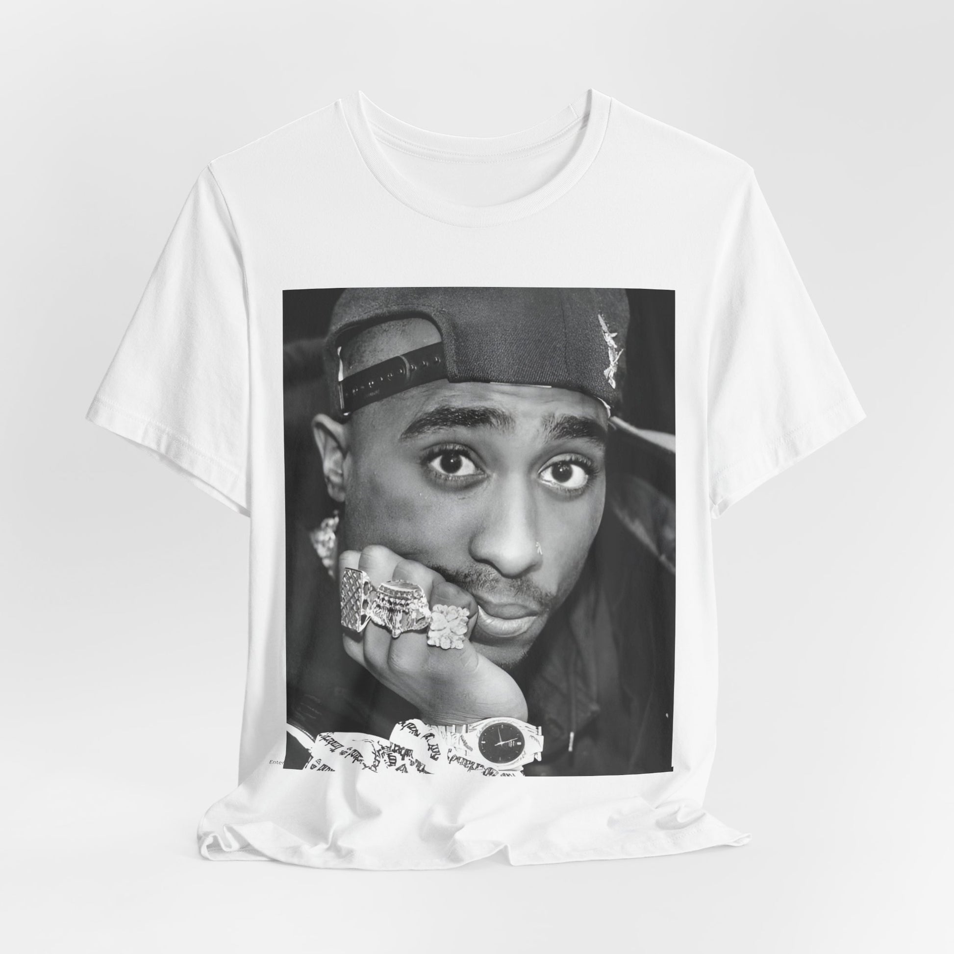 A black graphic t-shirt featuring a bold graphic of Tupac as a rap superstar.