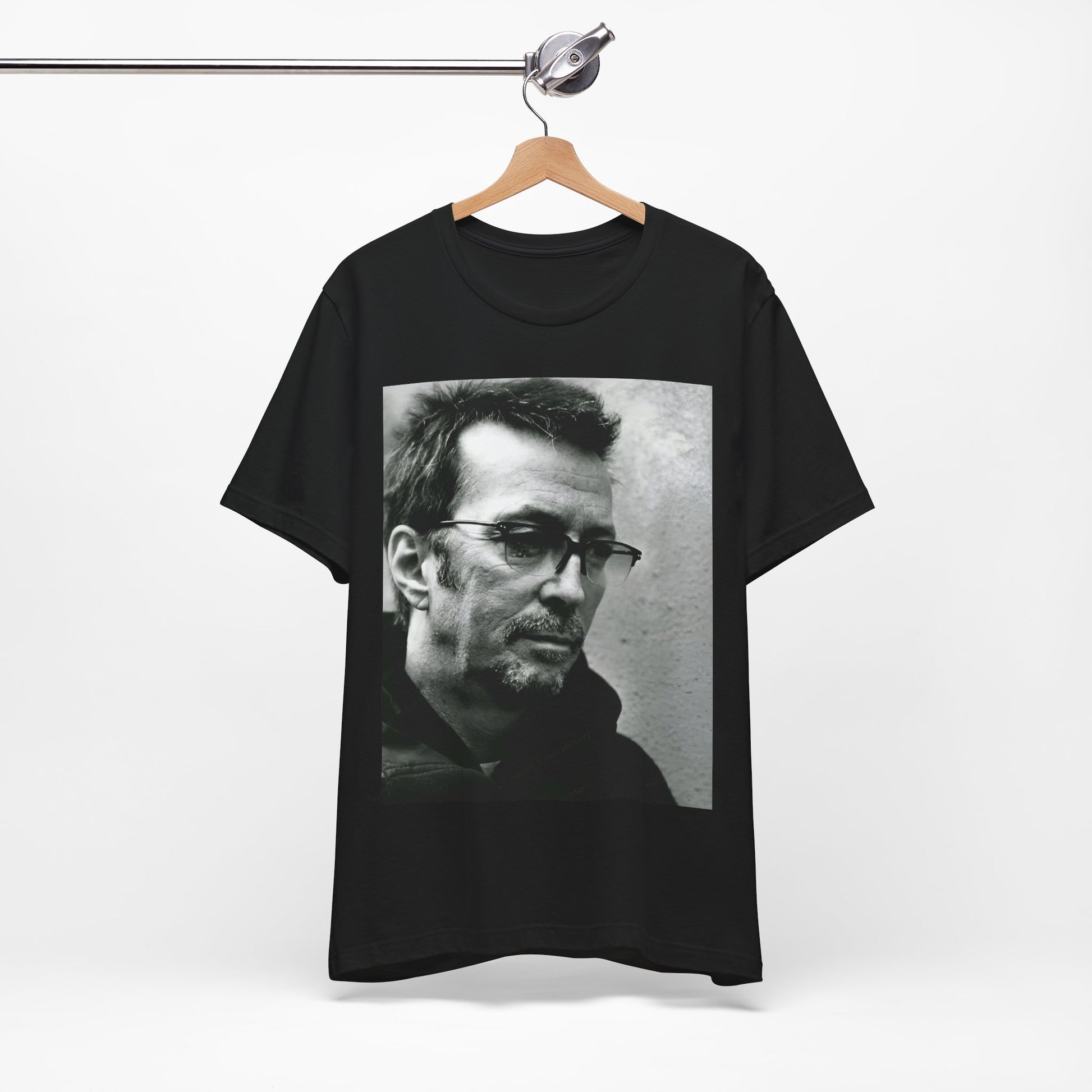 A black graphic t-shirt featuring a black and white, monochrome graphic or photo of Eric Clapton.