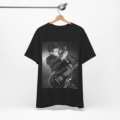 A black graphic t-shirt featuring a dynamic black and white graphic or photo of Arctic Monkeys performing live, emphasizing energy.