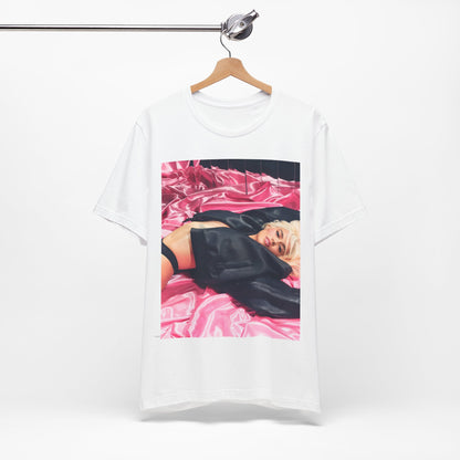 A black graphic t-shirt featuring a vintage aesthetic graphic related to Karol G's 'Tusa' era.