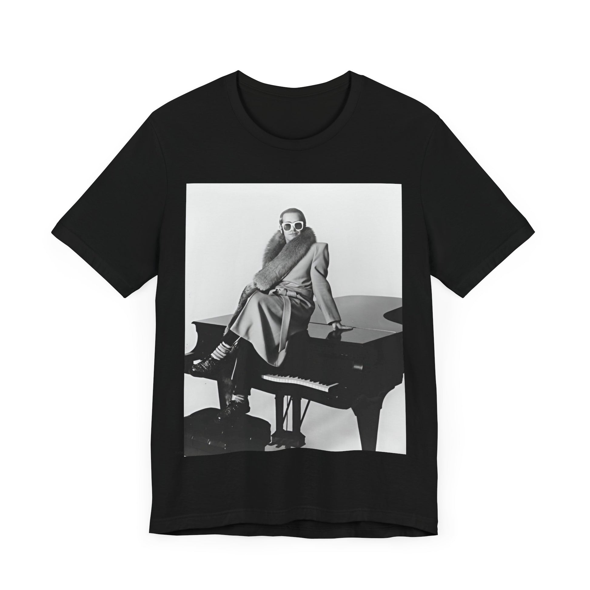 A black graphic t-shirt featuring a black and white photo of Elton John playing the piano.