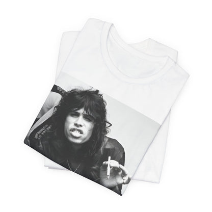 A black graphic t-shirt featuring a retro 70s photo of Aerosmith band members lounging in leather, exuding a cool, classic rock vibe.