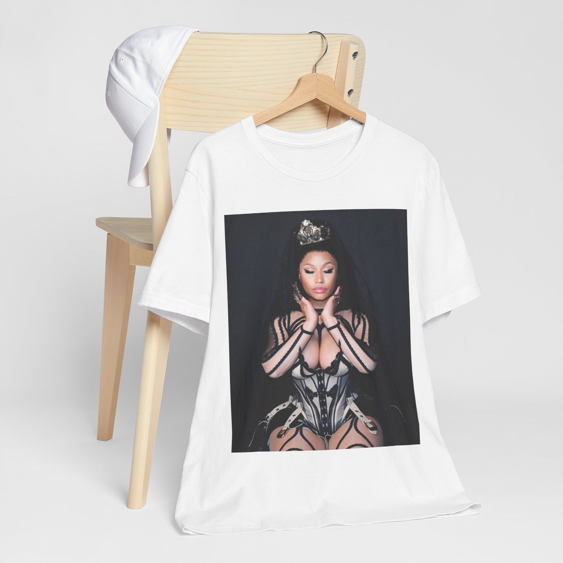 A black graphic t-shirt featuring a vintage graphic of Nicki Minaj as the Queen of Rap.