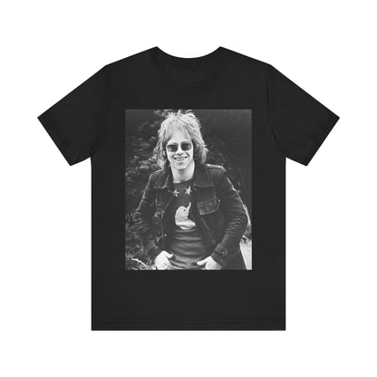A black graphic t-shirt featuring a 70s black and white monochrome graphic or photo of Elton John.