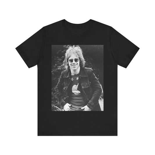 A black graphic t-shirt featuring a 70s black and white monochrome graphic or photo of Elton John.