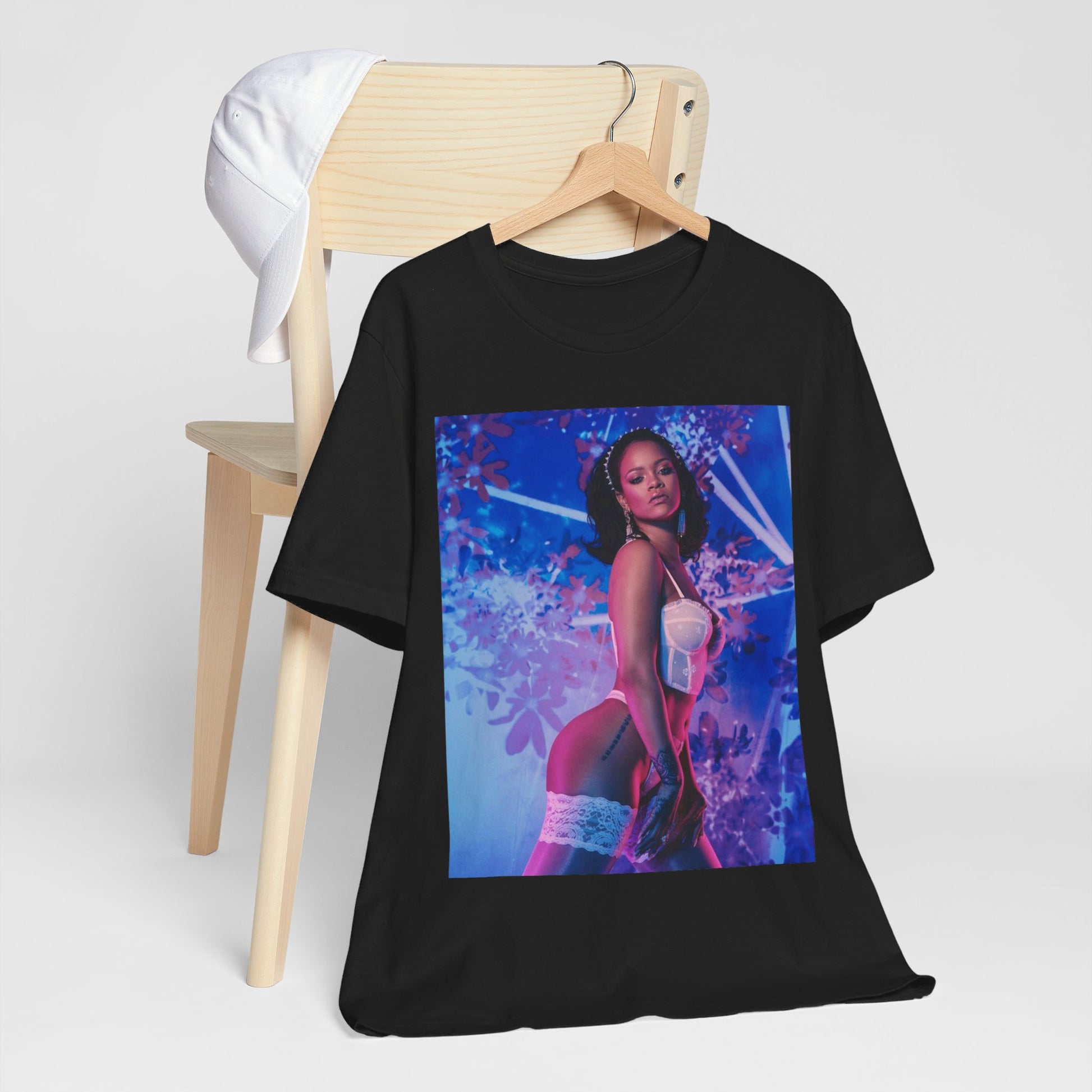 A black graphic t-shirt featuring a graphic of Rihanna as a lingerie goddess.