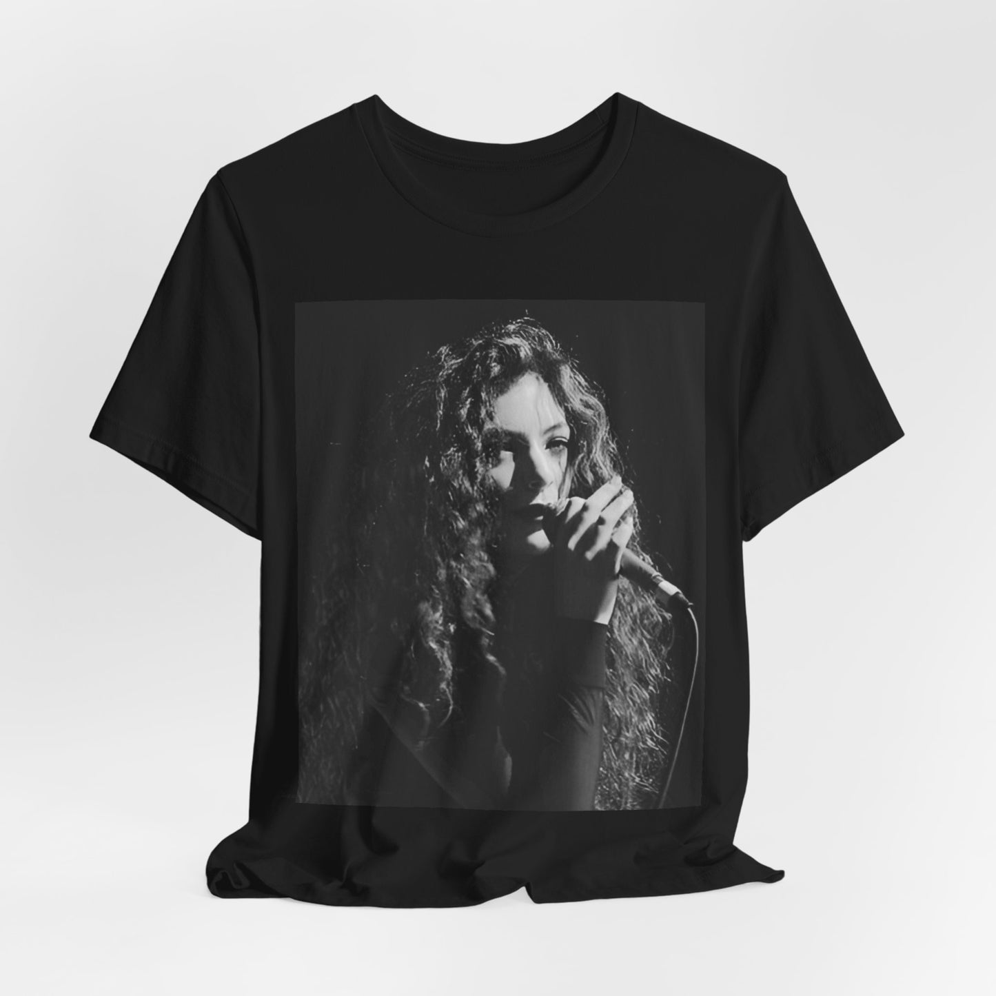 A black graphic t-shirt featuring a graphic or photo of Lorde performing live.