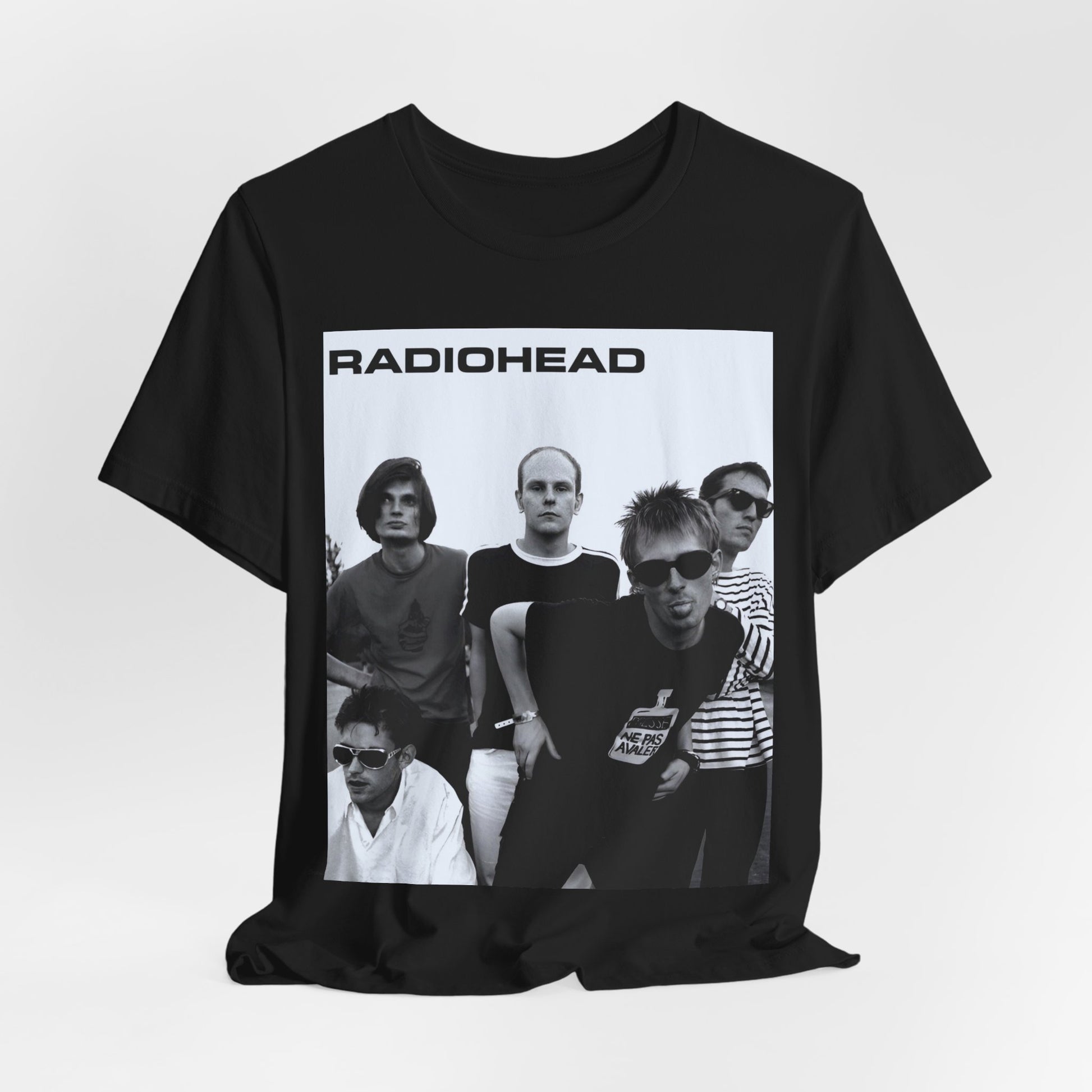 A black graphic t-shirt featuring a vintage 90s graphic related to Radiohead's 'Creep' song or era.