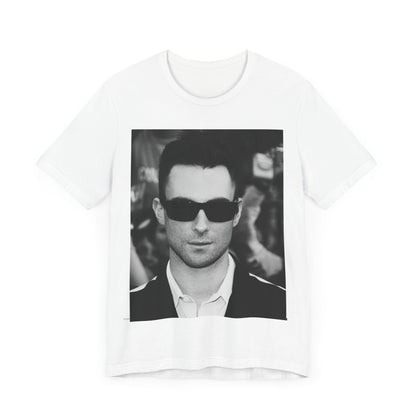 A black and white high-fashion photoshoot photo of Adam Levine, frontman of Maroon 5, looking confidently at the camera.