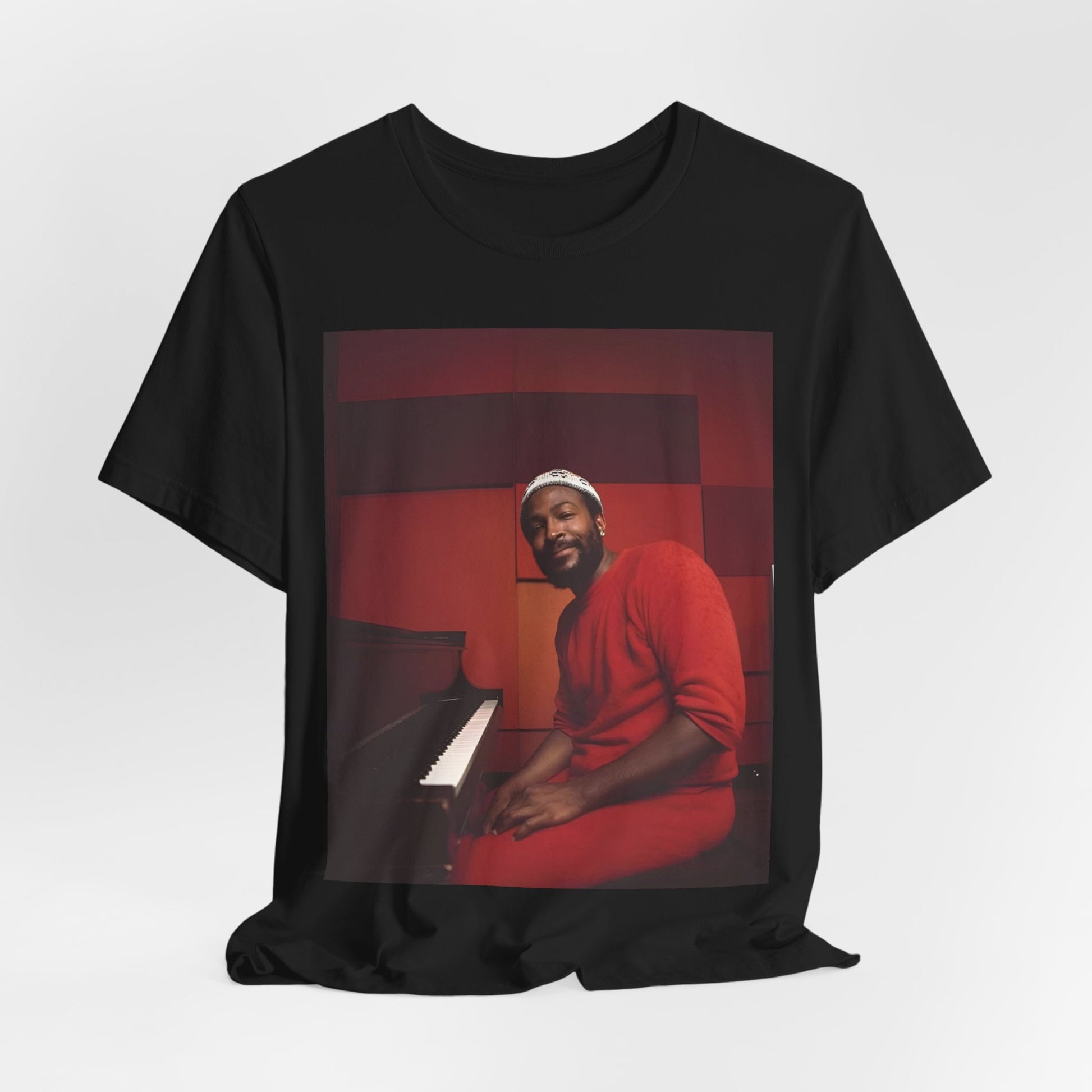 A black graphic t-shirt featuring a retro photo of Marvin Gaye playing the piano.