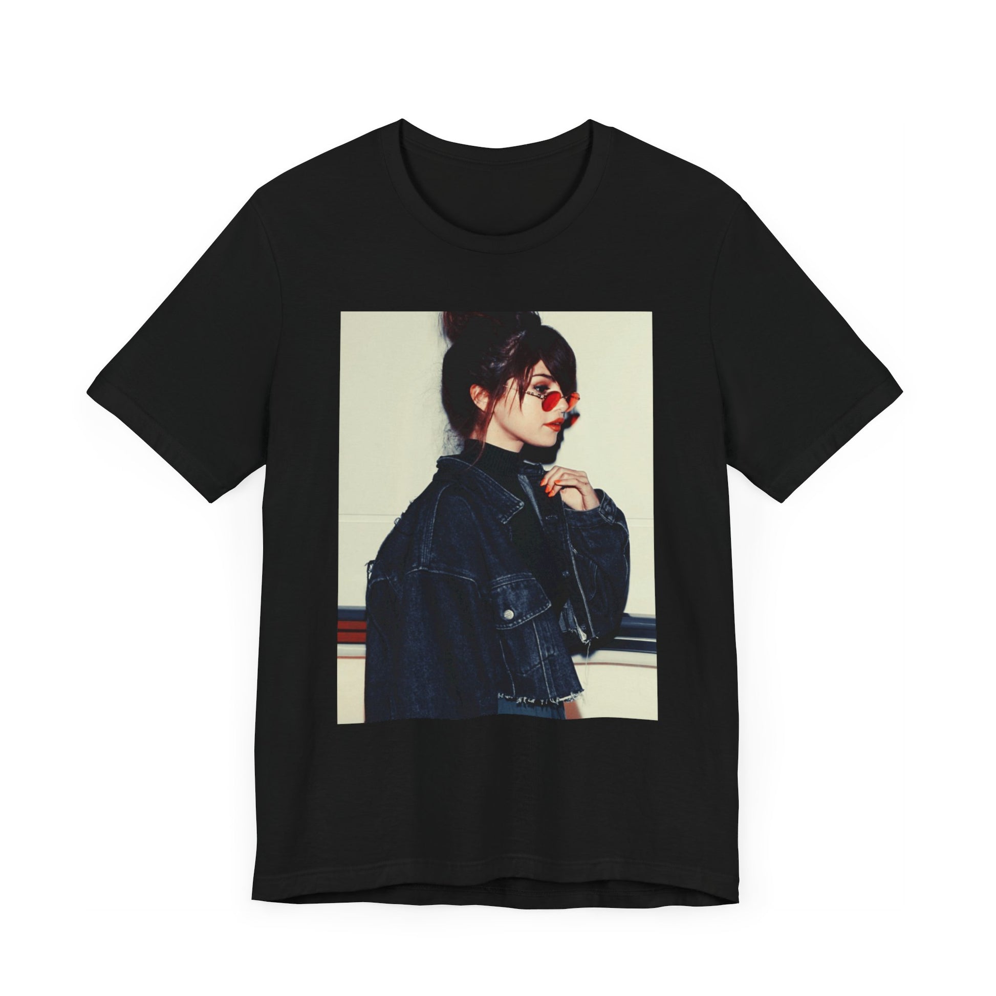 A black graphic t-shirt featuring a bold graphic of Selena Gomez as a pop superstar.
