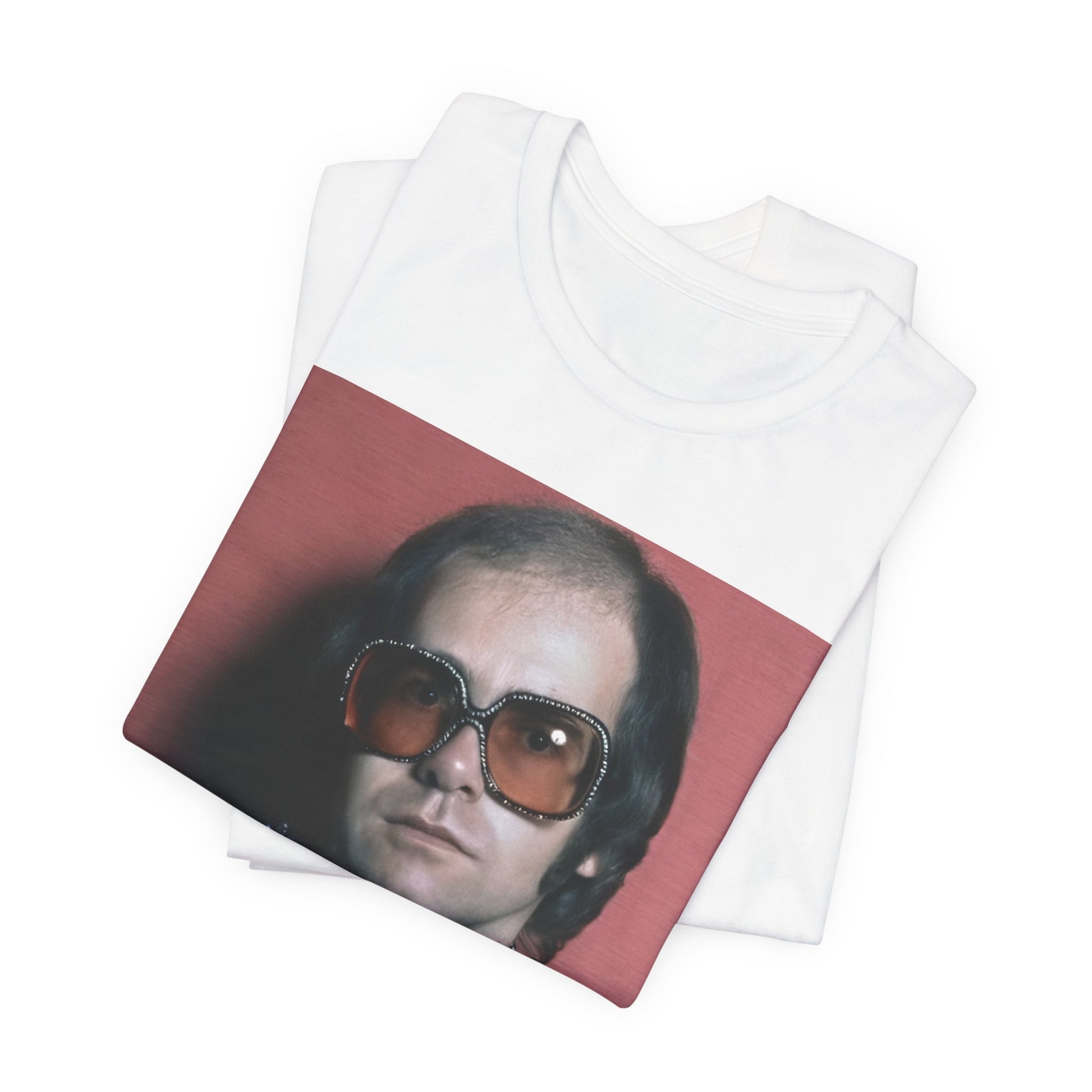 A black graphic t-shirt featuring a vintage glam rock icon graphic of Elton John.