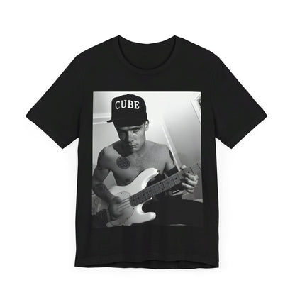 A black graphic t-shirt featuring a black and white graphic or photo of Flea from Red Hot Chili Peppers performing live on stage.