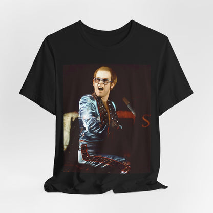 A black graphic t-shirt featuring a retro graphic related to Elton John's 'Rocket Man' song or era.