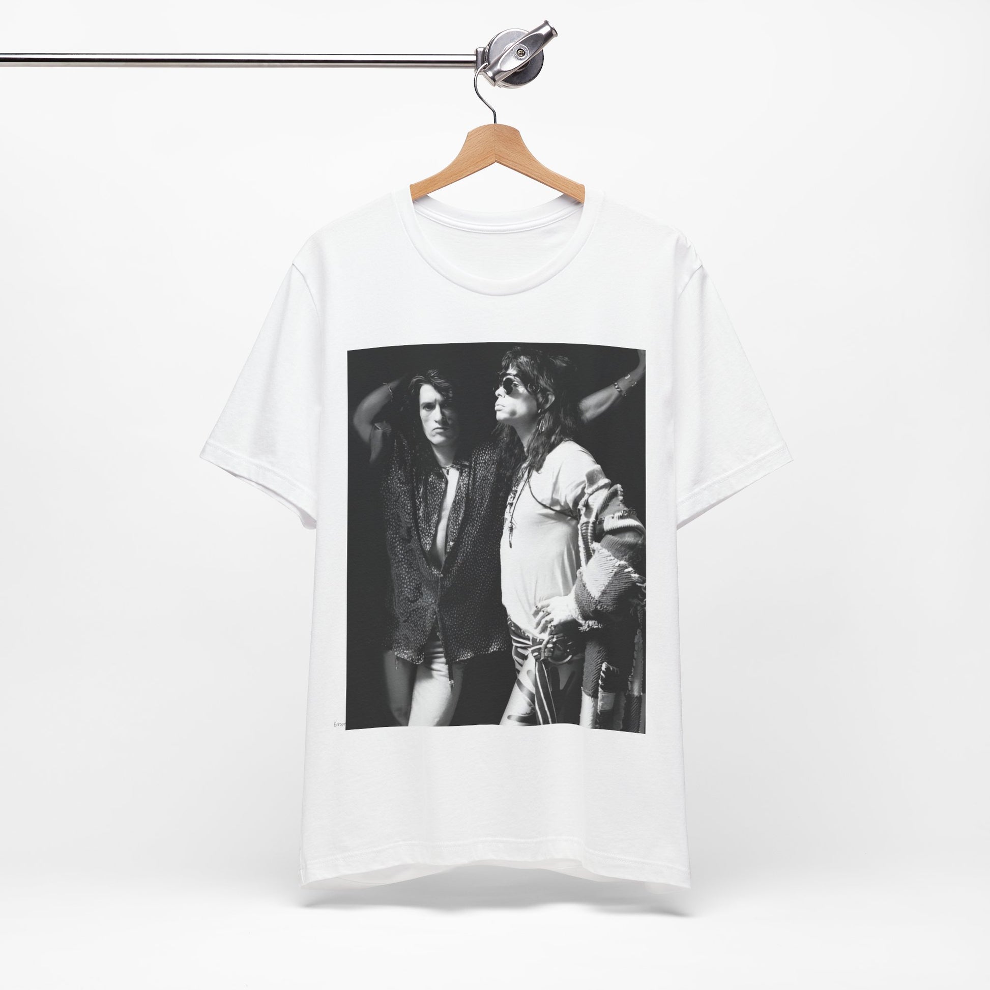 A black graphic t-shirt featuring a dynamic photo or illustration of Aerosmith's Steven Tyler and Joe Perry performing together on stage, highlighting their synergy.