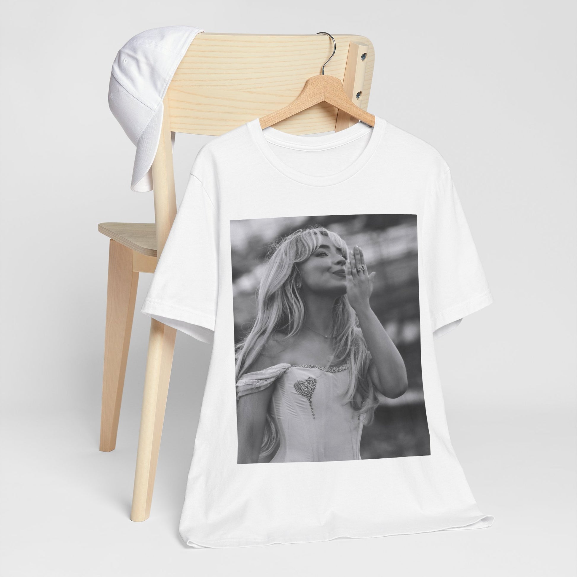 A black graphic t-shirt featuring a graphic or photo of Sabrina Carpenter kissing on stage during a performance.