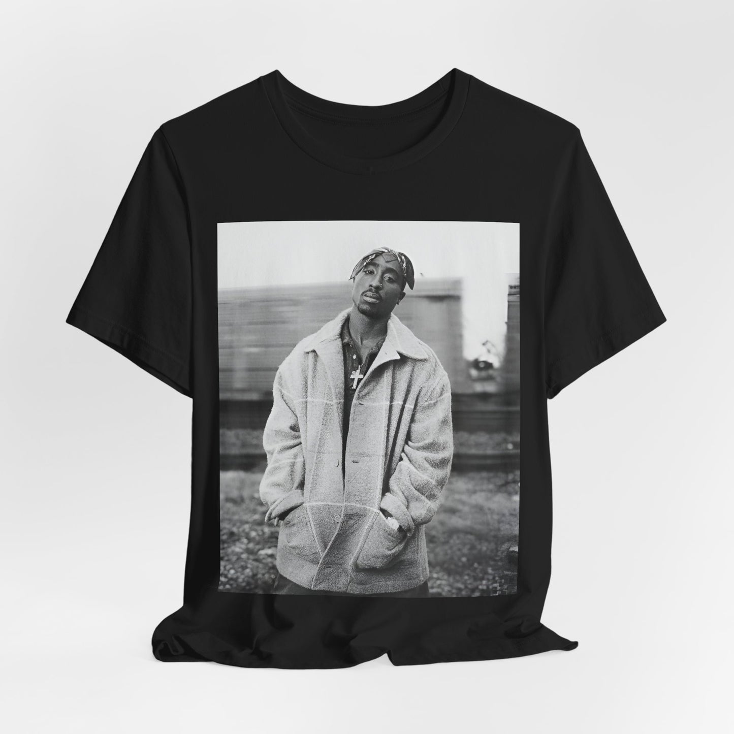 A black graphic t-shirt featuring a graphic related to Tupac's 'Thug Life' philosophy.