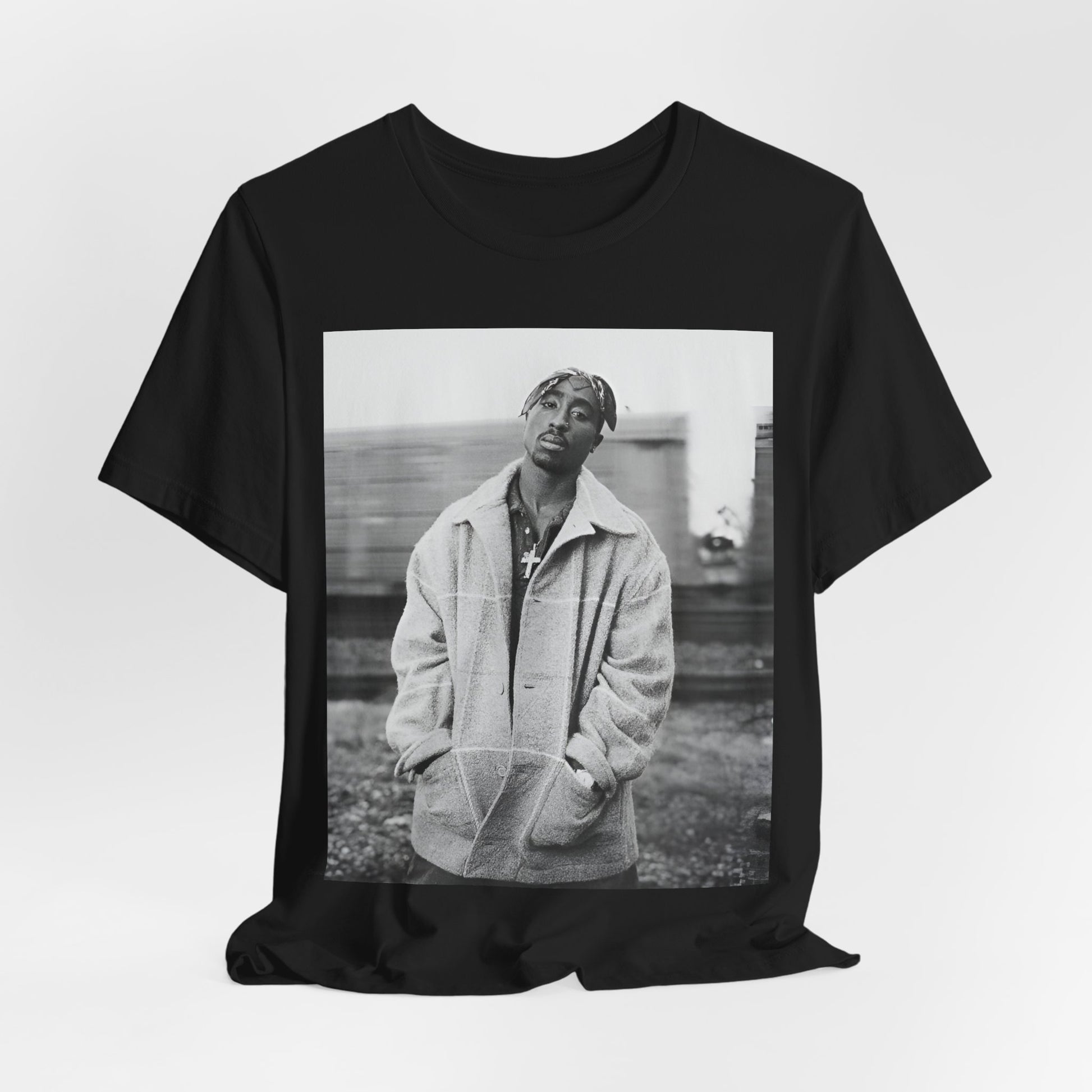 A black graphic t-shirt featuring a graphic related to Tupac's 'Thug Life' philosophy.