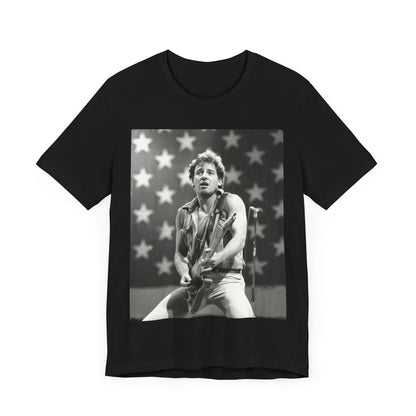 A black graphic t-shirt featuring a black and white graphic of Bruce Springsteen with an American flag background or elements.