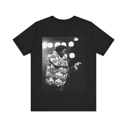 A black graphic t-shirt featuring a graphic or photo of Barry White performing live on stage in the 1970s.