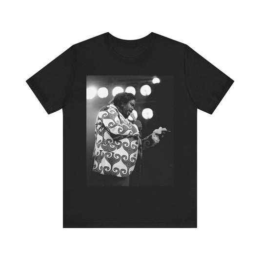 A black graphic t-shirt featuring a graphic or photo of Barry White performing live on stage in the 1970s.