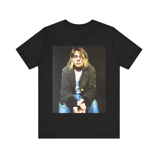 A black graphic t-shirt featuring an iconic graphic of Kurt Cobain from Nirvana.