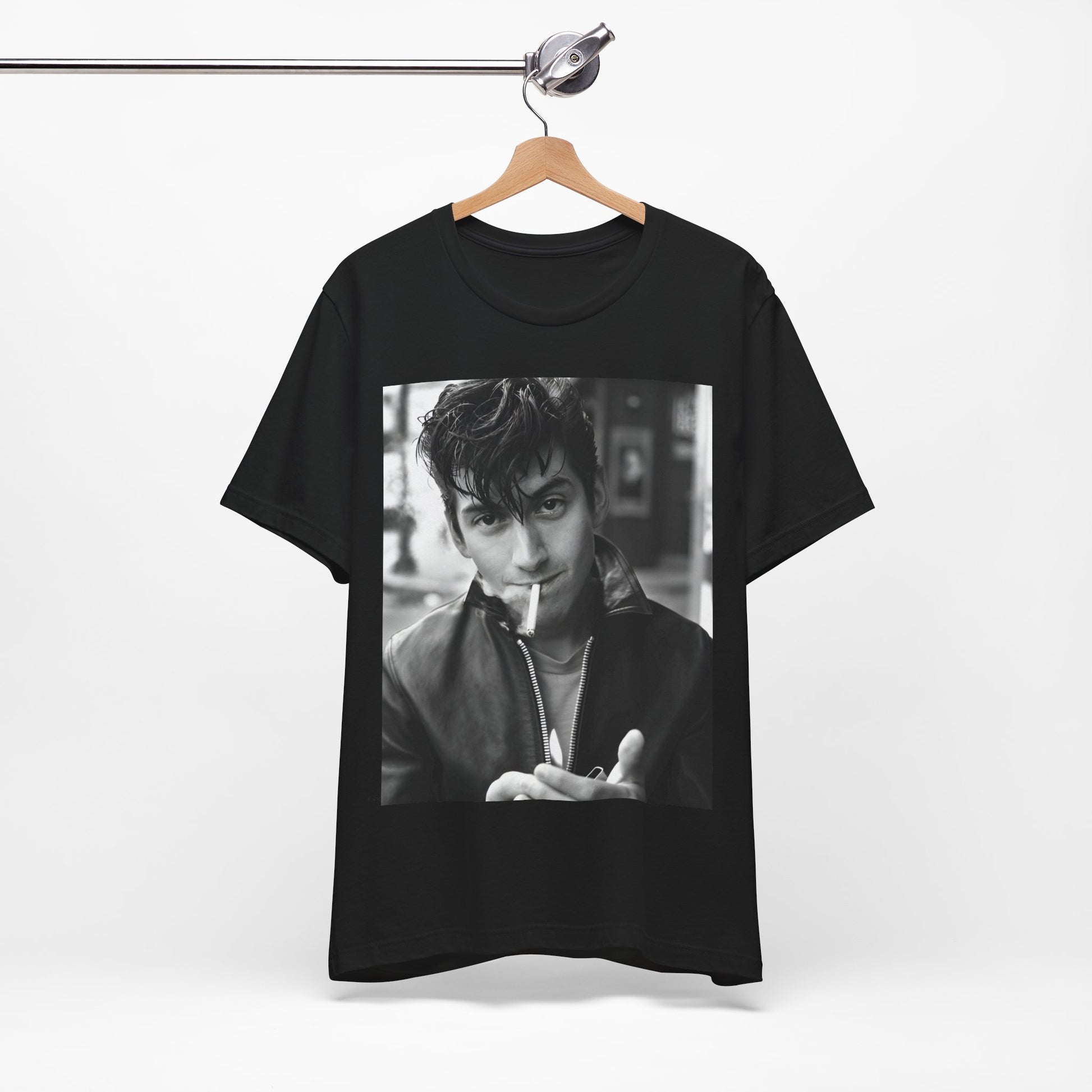 A black graphic t-shirt featuring a graphic of Alex Turner from Arctic Monkeys, in a rock star pose or setting.