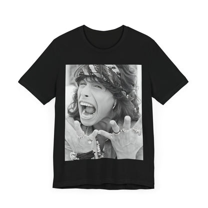 A black graphic t-shirt featuring a candid, dynamic photo of Aerosmith band members on tour in the 1970s, possibly showing action or interaction on stage or backstage.
