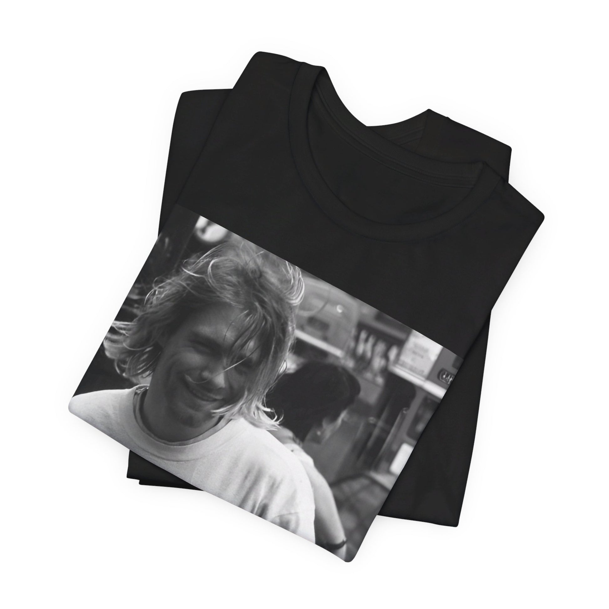 A black graphic t-shirt featuring a vintage rock legends graphic of Nirvana.