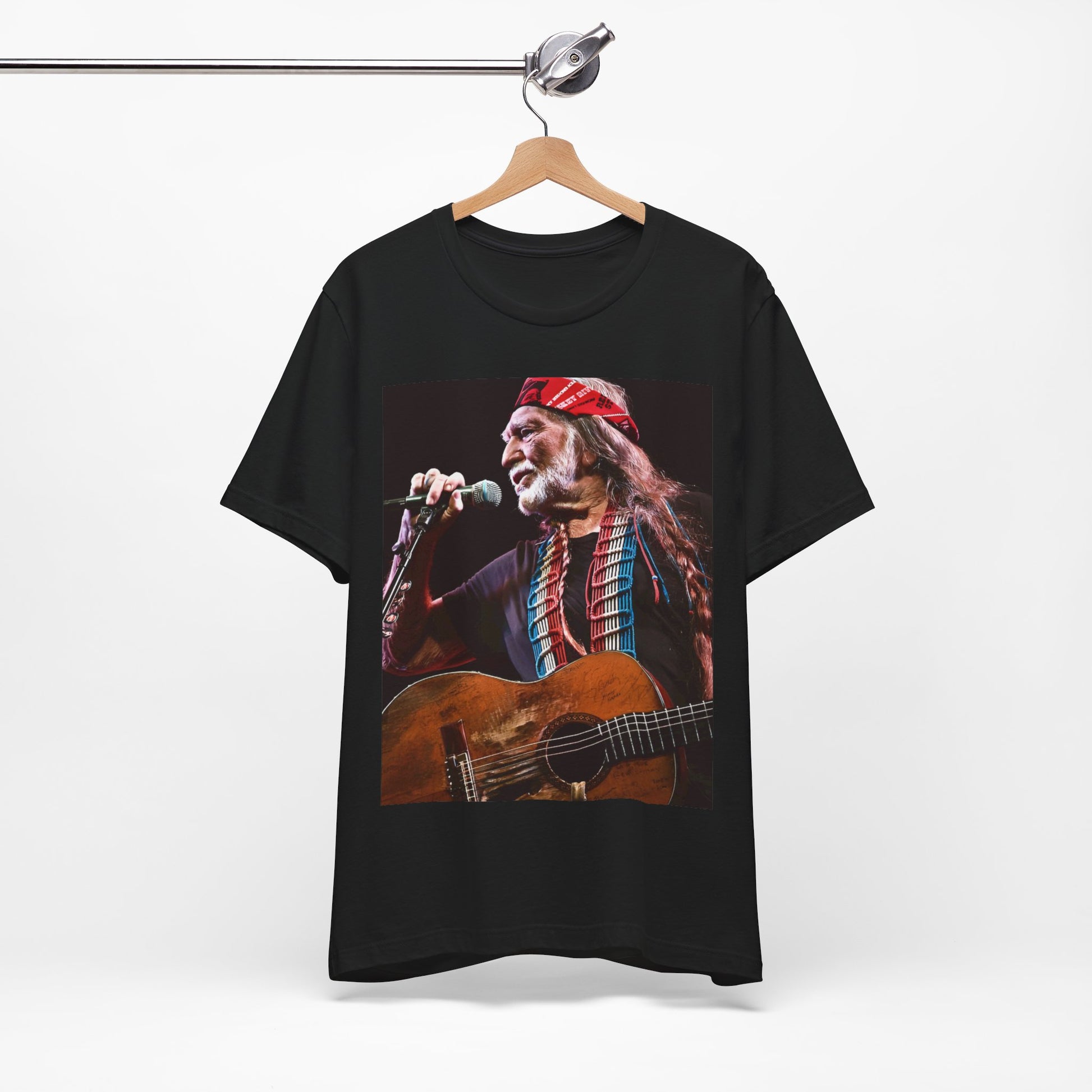 A black graphic t-shirt featuring a graphic of Willie Nelson with his iconic long hair and bandana.