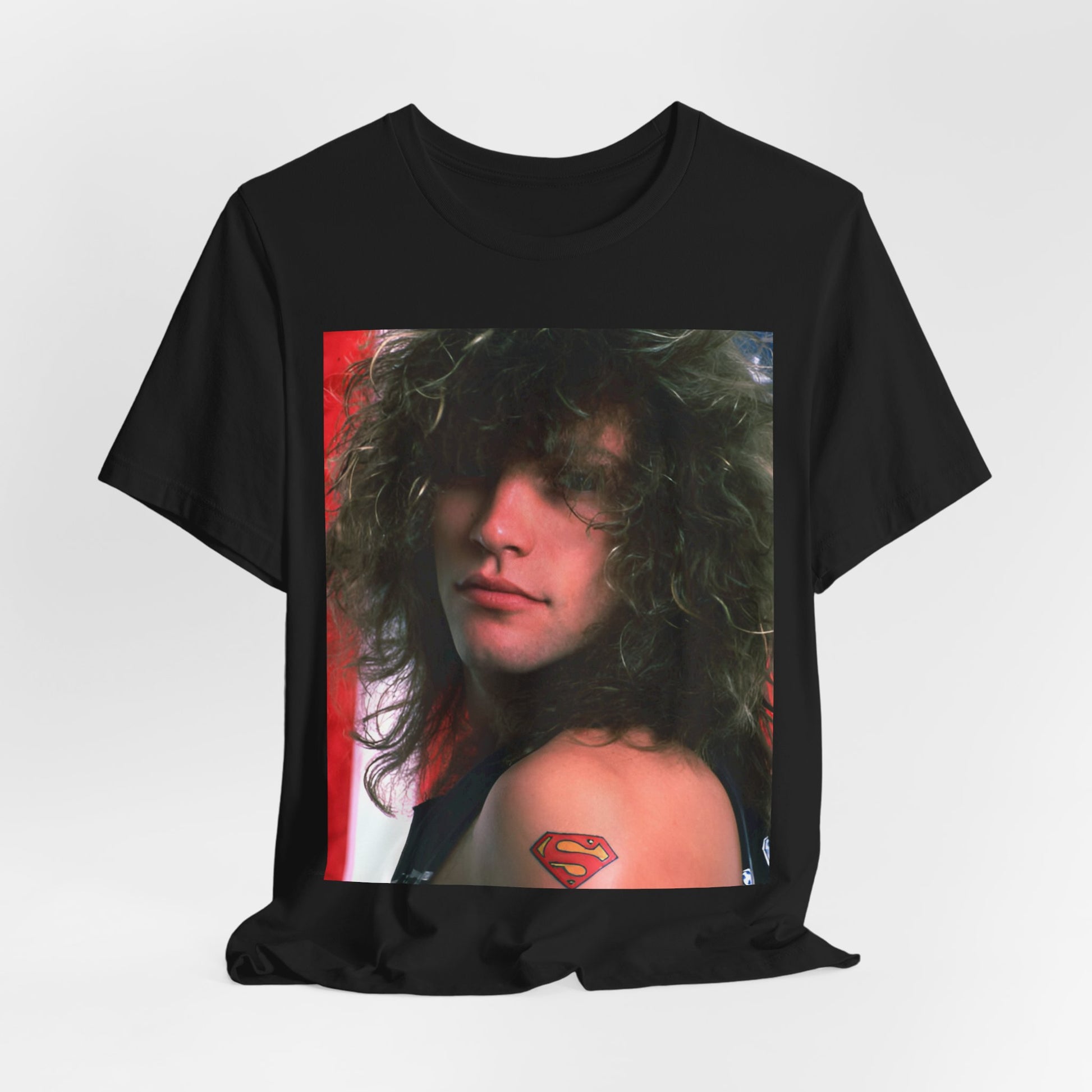 A black graphic t-shirt featuring a graphic of Bon Jovi, possibly with a Superman logo or a tattoo-inspired design.