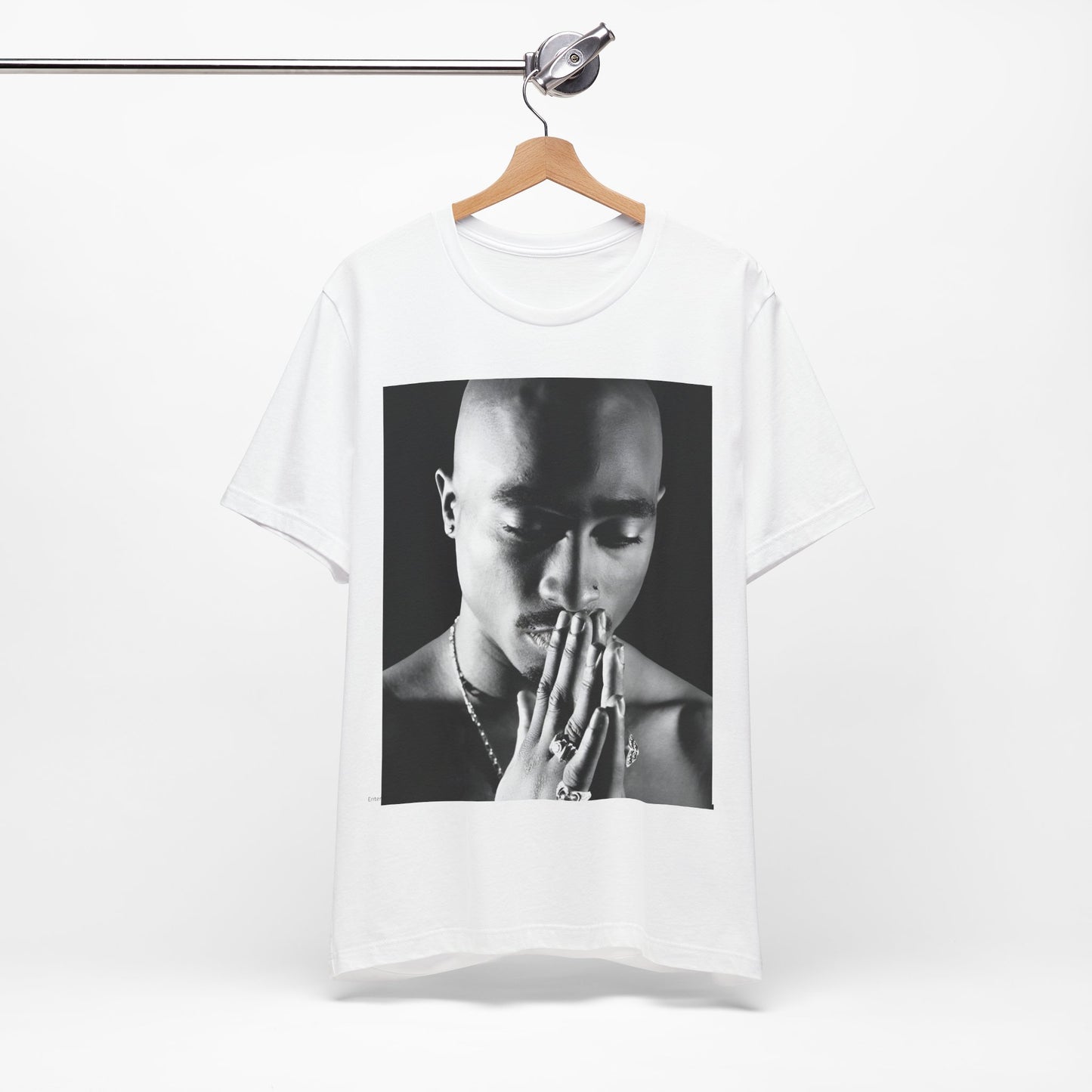 A black graphic t-shirt featuring a black and white streetwear rebel graphic of Tupac.