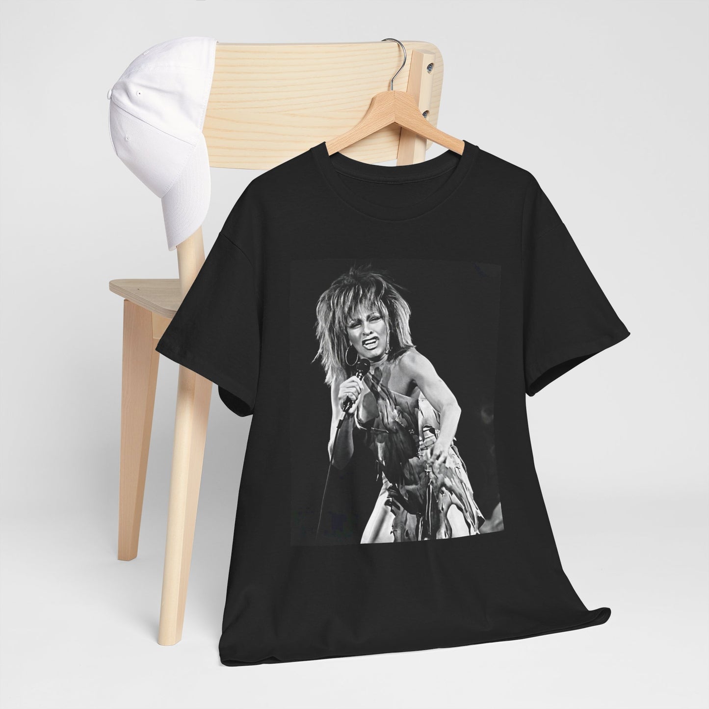 A black graphic t-shirt featuring a graphic of Tina Turner as an inspiring legend.