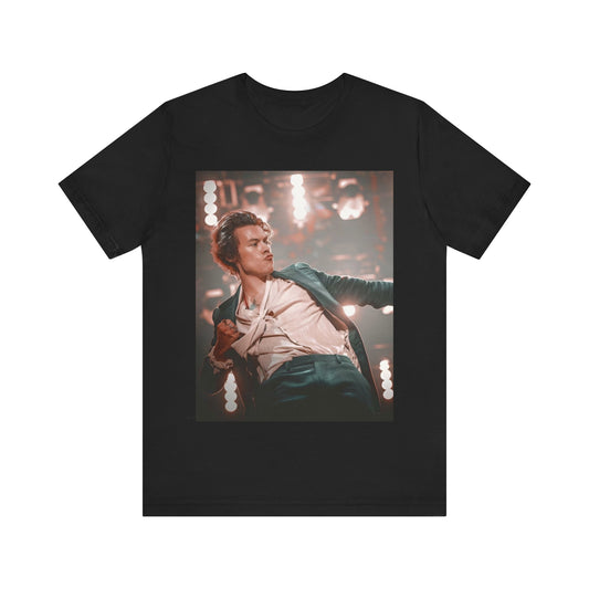 A black graphic t-shirt featuring a graphic or photo of Harry Styles performing live on concert tour.