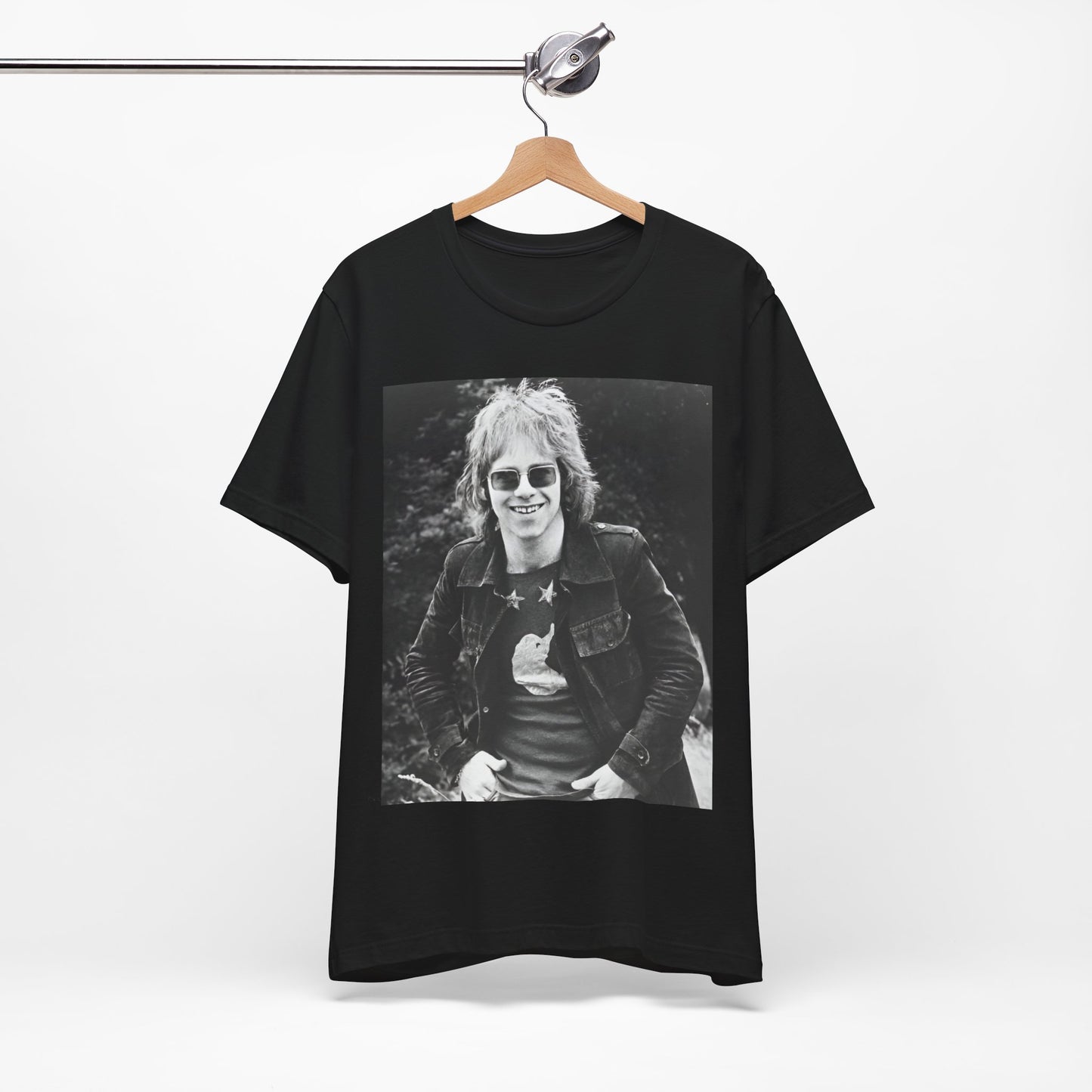 A black graphic t-shirt featuring a 70s black and white monochrome graphic or photo of Elton John.