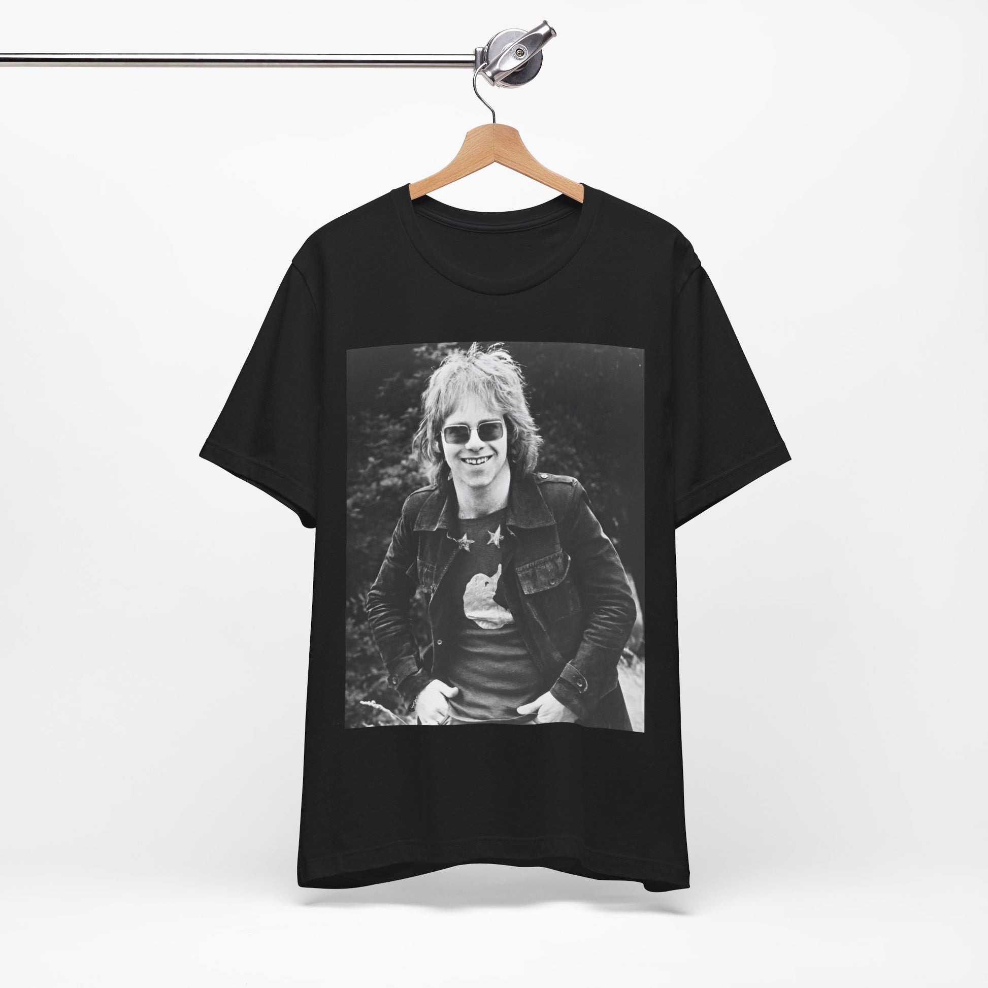 A black graphic t-shirt featuring a 70s black and white monochrome graphic or photo of Elton John.