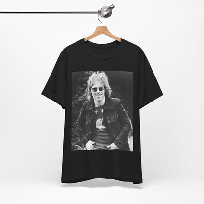 A black graphic t-shirt featuring a 70s black and white monochrome graphic or photo of Elton John.