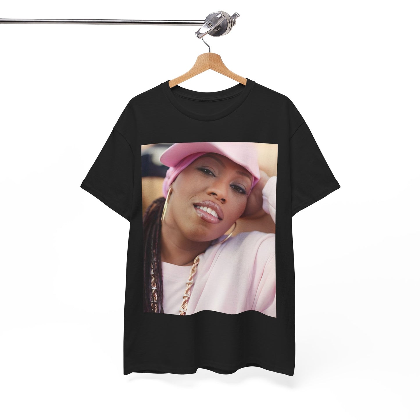 A black graphic t-shirt featuring a 90s rap graphic of Missy Elliott from her early days, emphasizing a raw style.