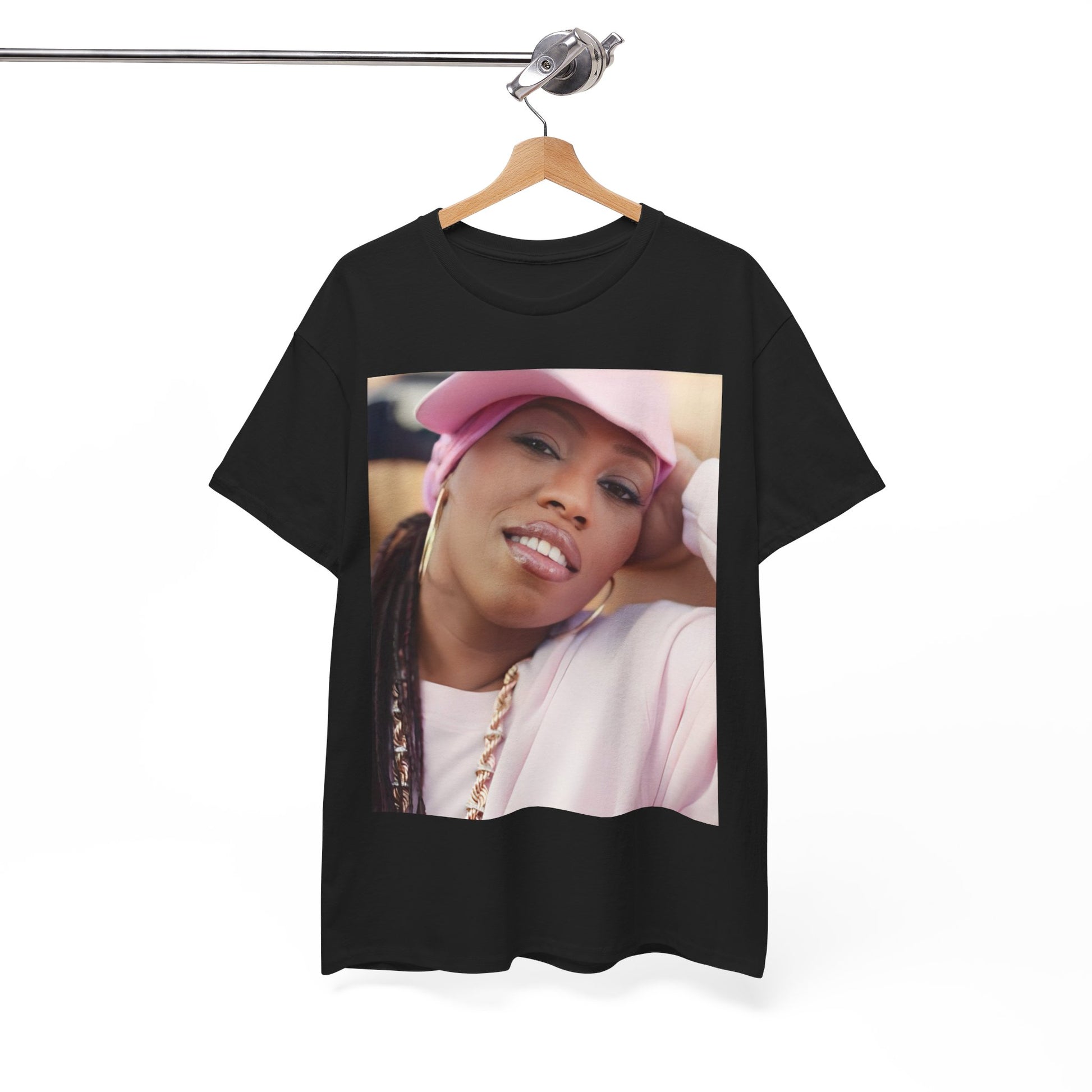 A black graphic t-shirt featuring a 90s rap graphic of Missy Elliott from her early days, emphasizing a raw style.
