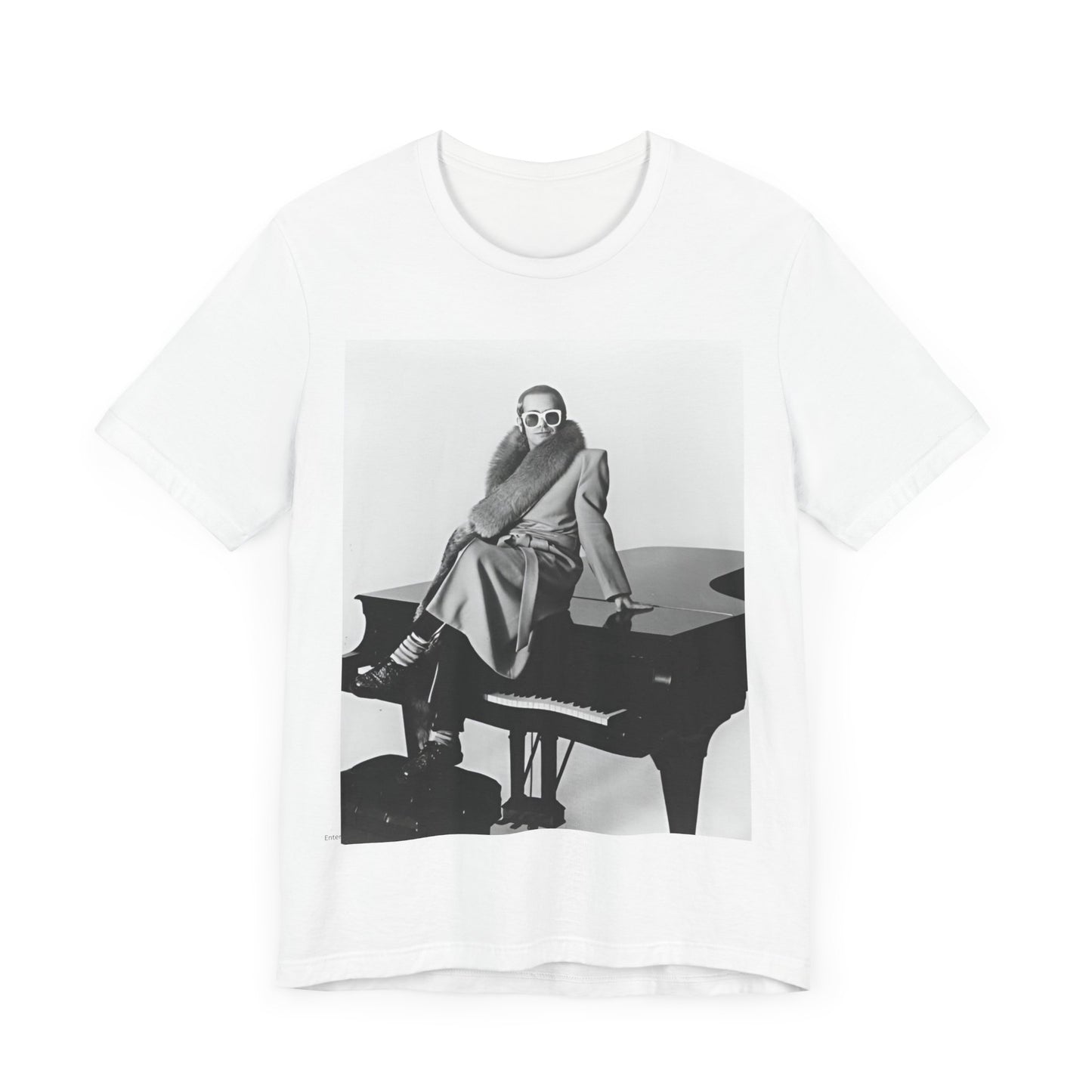 A black graphic t-shirt featuring a black and white photo of Elton John playing the piano.
